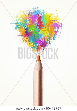 Colored pencil close-up with colored paint splashes