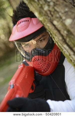 Young Children Playing Paintball In The Woods