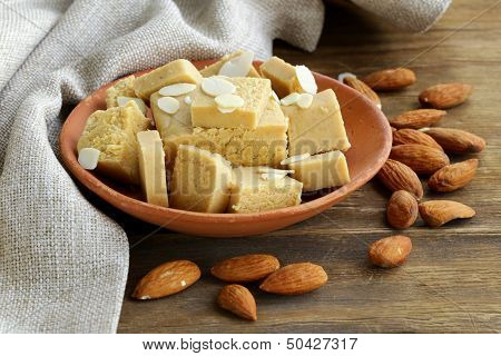 almond paste - marzipan in a bowl with whole nuts