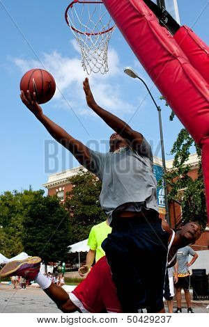 Man Shoots Reverse Layup In Outdoor Street Basketball Tournament