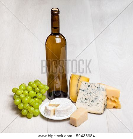 wine bottle and different kinds of cheese