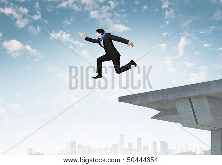 Image of jumping businessman at the edge of bridge