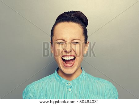 screaming young girl over grey background