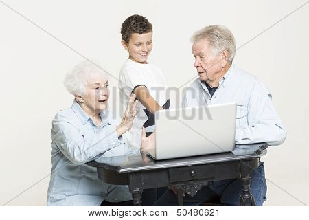 Grandson explains computer problems to grandparents