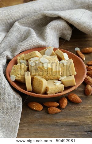 almond paste - marzipan in a bowl with whole nuts