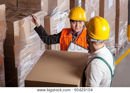 Manager Giving Worker Instruction In Warehouse