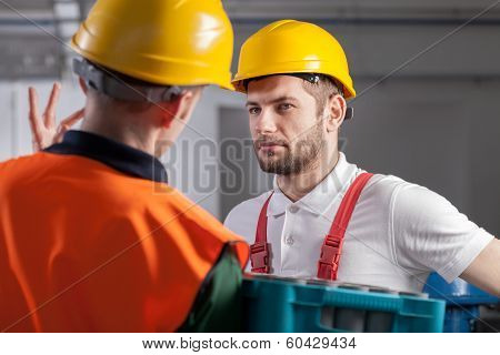 Worker Consulting With Manager In Factory