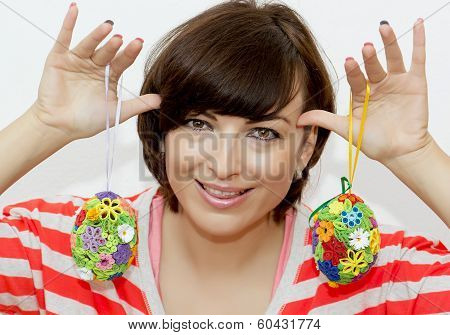 Young Woman Joking With Decorative Easter Eggs