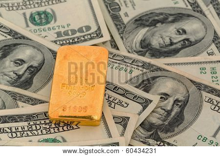 gold bars on dollar bills, symbolic photo for gold reserves, exchange rates, investment, security