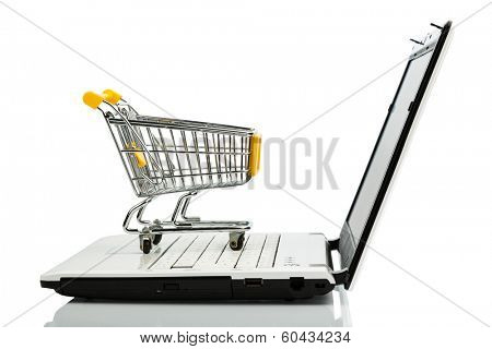 shopping cart is on the keyboard of a laptop, symbol photo for online shopping and consumer behavior
