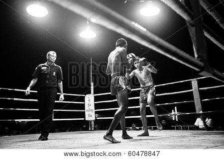 CHANG, THAILAND - FEB 22, 2013: Unidentified Muaythai fighter in ring during match (black and white series). For many Thai men, Muaythai only way to break out of poverty, per battle pay to 7000 baht.
