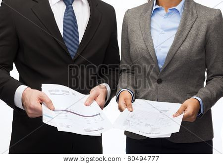 business and economy concept - smiling businesswoman and businessman with files and forms