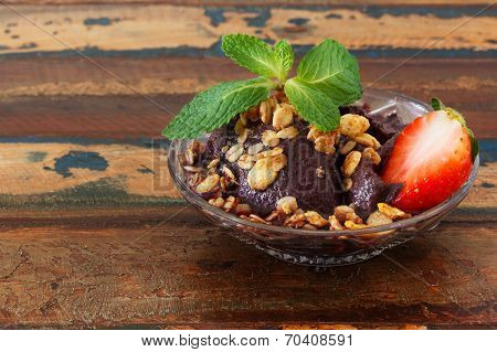Acai Pulp In Glass With Strawberry, Muesli And Fresh Mint On Wooden Table