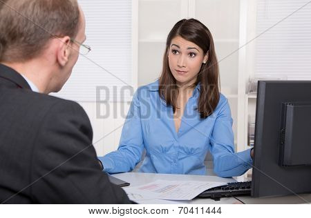 Client And Customer Sitting At Desk Or Communication Concept For Workplace Problems Under Colleagues