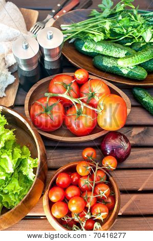 Homegrown Vegetables In Wooden Dishware For Spring Picnic.