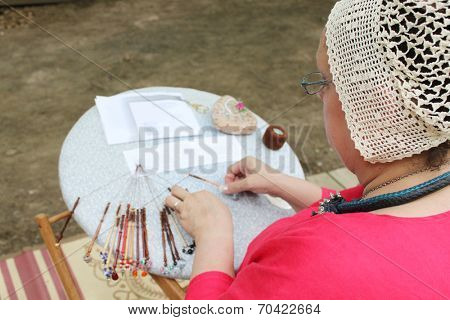 MUSKOGEE, OK - MAY 24: Women show art of lace making, as it was made in the Middle Ages, at the Oklahoma 19th annual Renaissance Festival on May 24, 2014 at the Castle of Muskogee in Muskogee, OK 