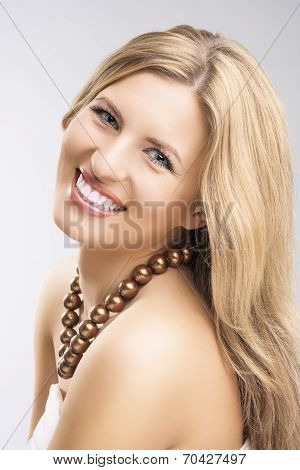 Beauty Concept: Portrait Of Smiling Caucasian Blond Woman Over Gray Studio Backdrop. Long Haor And B