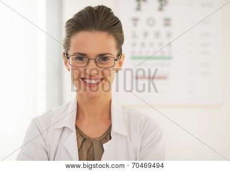 Doctor Woman In Eyeglasses In Front Of Snellen Chart