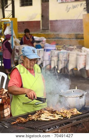 Roasting Chicken Legs at Market in Banos, Ecuador