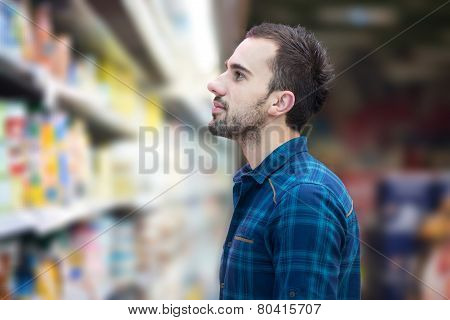 Smiling Man Buying Dairy Products In Supermarket
