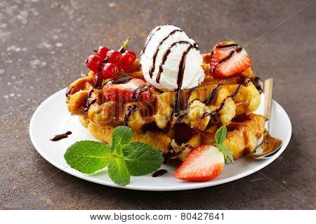 Belgian waffles with berries (currants, strawberries) and ice cream