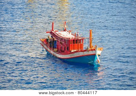 Fishing boat heading out to the gulf in the early morning