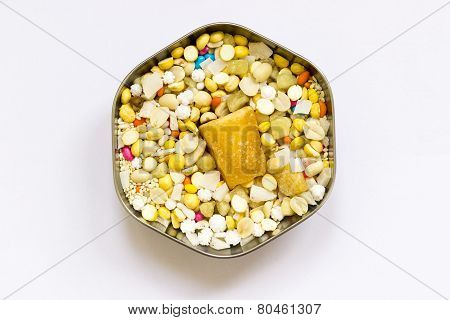 A hexagonal cup filled with dry nuts and sweets as per Indian traditional offerings to Hindu temple