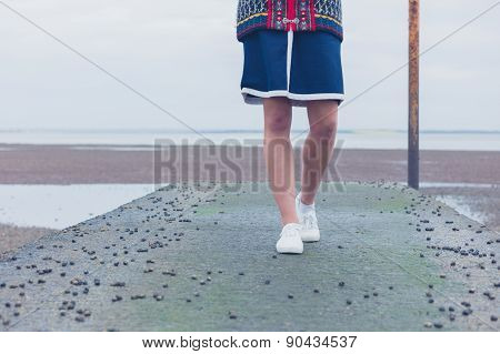 Woman Walking On Pier With Whelks