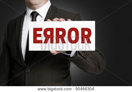Error Sign Held By Businessman