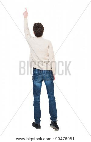 Back view of pointing business man. gesticulating young guy in black suit. Rear view people collection.  backside view of person.   The man saw something high up.