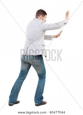 back view of business man pushes wall. Isolated over white background. Rear view people collection. backside view of person.  Bearded man ran into an obstacle.