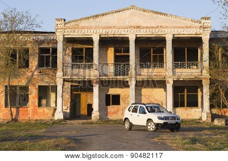 White Renault Duster near abandoned building