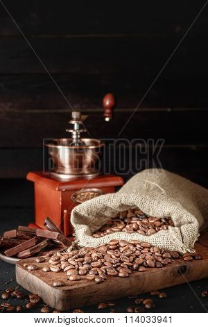 Still Life Of Coffee Beans In Jute Bags With Coffee Grinder