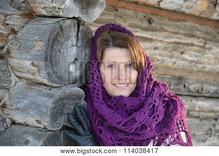 The Russian Woman In  Shawl Warms Hands Near An Izba