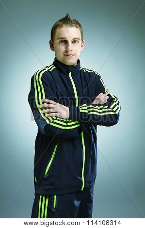 Young soccer player posing in track suit instudio for figure and portrait photos.