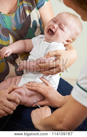 Crying Baby Being Given Injection By Nurse