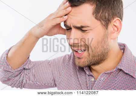 Handsome Young Man Touching His Head With One Hand Feeling Strong Headache, Close Up Photo