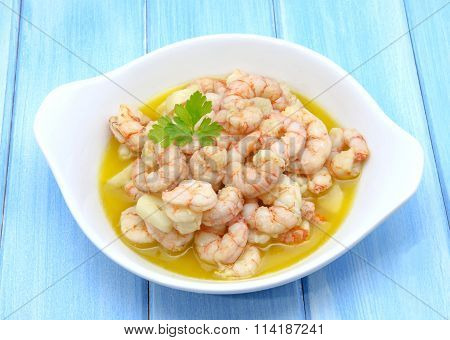 Garlic Prawns Served On A Plate On A Wooden Table