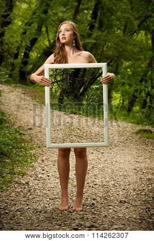 Lady Nature - Beoutiful Young Wman Stands In Nature With A Frame That Makes Her Transparent And Stre