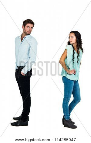Sad couple standing back to back not talking after argument on white screen