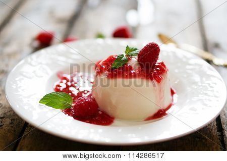 Delicious Italian Dessert Panna Cotta With Raspberry Sauce And Mint On White Background
