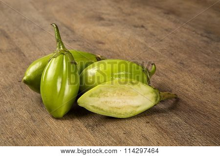 Some Green African Eggplants Over A Wooden Surface