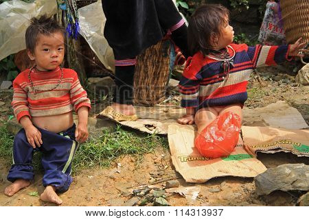children are sitting outdoor in CatCat village, Vietnam