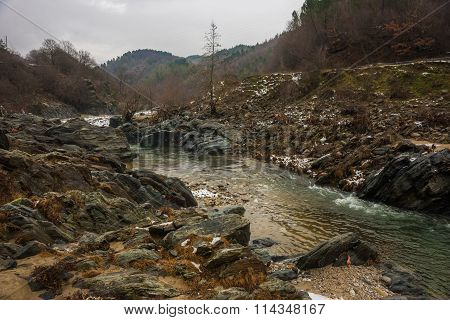 River With Green Waters, Snow And Ice Near Xanthi In Greece