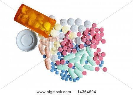 Orange bottle and colorful pills isolated on white