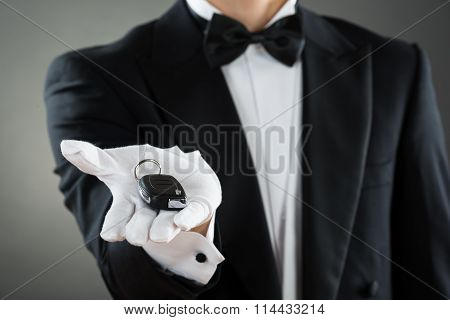 Midsection Of Waiter Holding Car Key