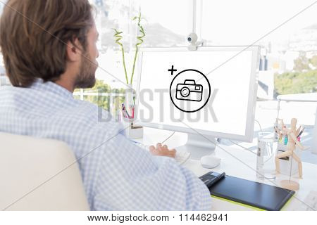 Desinger working on his computer against photography apps