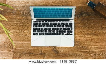 Laptop On Vintage Wooden Desktop
