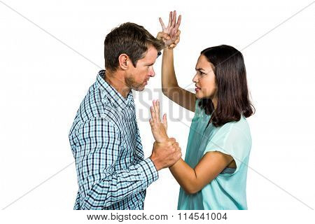 Angry couple fighting against white background
