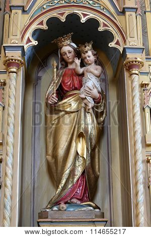 STITAR, CROATIA - AUGUST 27: Virgin Mary with baby Jesus statue on altar of Our Lady in the church of Saint Matthew in Stitar, Croatia on August 27, 2015